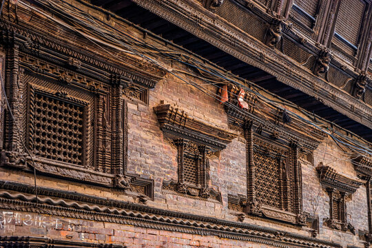Nepali traditional carved wooden windows and balcony, a detail of the old newar building in Bhaktapur town, Nepal.