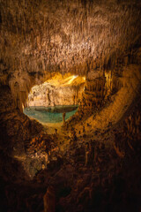 Stalactites hanging over lake martel in caves of drach, mallorca, spain