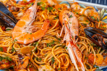 A plate of spaghetti with shrimp and mussels