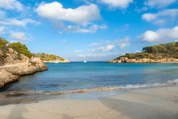 Sailboats anchoring in the turquoise waters of s'amarador beach, mallorca