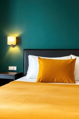 Minimalist bedroom design featuring terracotta bedspread, deep teal wall, and ambient lighting for a cozy atmosphere