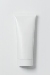 top-down view of minimalist sunscreen tube featuring blank white label elegantly styled on white background with subtle