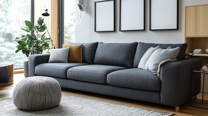Fototapeta premium Modern gray sofa with pillows and ottoman in minimalist living room.