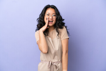 Restaurant asian waiter isolated on purple background with surprise and shocked facial expression