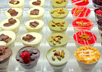 Variety of desserts with chocolate, nuts, caramel in glass. Pistachio cream and breakfast. Traditional cuisine. 