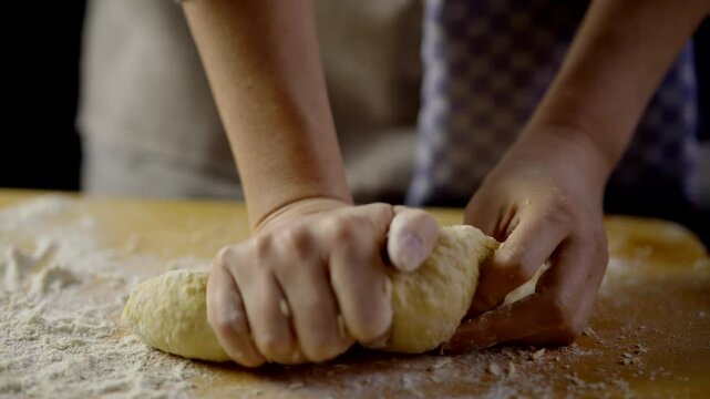 Hands kneading dough for homemade bread or pastries 	