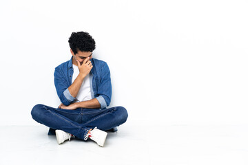 Venezuelan man sitting on the floor laughing