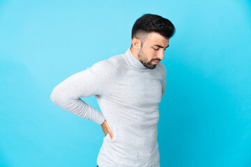 Caucasian man over isolated blue background suffering from backache for having made an effort
