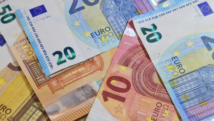 Zenith view. Background euro bills, of various amounts scattered. 