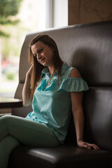 Portrait of a young beautiful long-haired girl, in light clothes in summer.