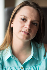 Portrait of a young beautiful long-haired girl, in light clothes in summer.