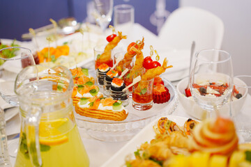 A served festive table with a variety of appetizers. catering for a banquet.