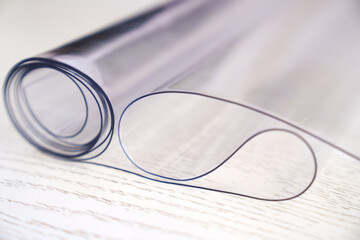 A roll of transparent PVC film to protect surfaces. Thermoplastic polyvinyl chloride made on the...