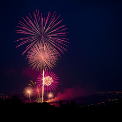a very lively colorful fireworks party at night in the middle of the city