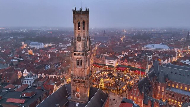 Christmas market lights up Bruges' evening skyline with festive charm and vibrant atmosphere