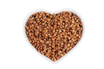 Raw buckwheat in ceramic bowl isolated on white background. Top view. Flat lay