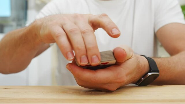 male hands shuffle a deck of playing cards. gambling. A board game for spending leisure time with friends and family.