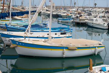 Fototapeta premium View on French Riviera, old port with little fisherman foard, Menton old city and marina on blue Mediterranean Sea near French-Italian border, travel destination