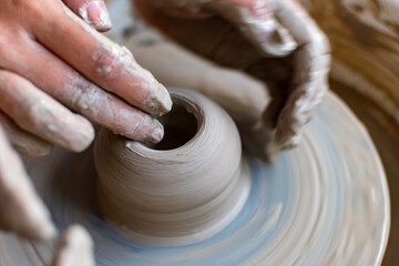 Making of mud pot on potters wheel during workshop in art ceramic atelier in Poland