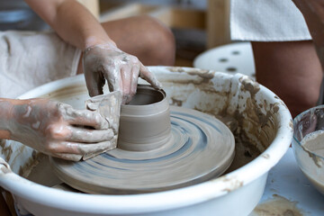 Making of mud pot on potters wheel during workshop in art ceramic atelier in Poland