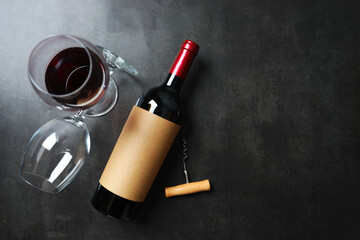 Bottle of red wine with wine glasses on black background