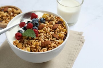 Delicious granola with berries and yogurt on a light background