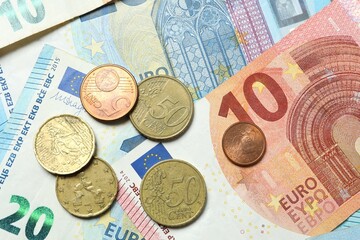 Euro banknotes and euro cents close up. Money is scattered on the table. Finance and economics concepts. Money accumulation concept. Currency saving. Investment. Copy space