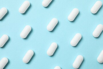 White pills on color background