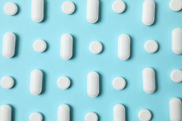 White pills on color background