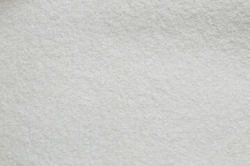 White cuddle teddy bear fabric as background, top view