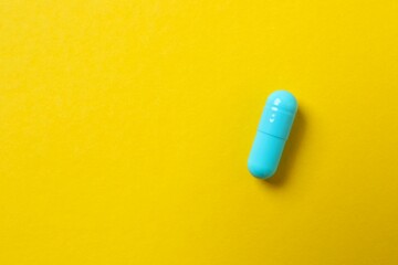 Various pills on color background