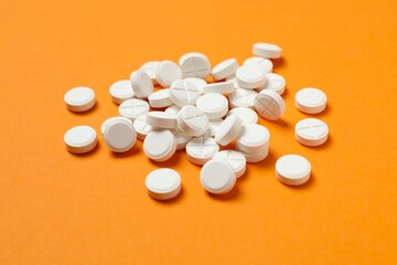 White pills on color background