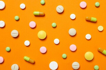 Various pills on color background