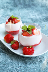 Red strawberries with whipped cream dessert on wooden background