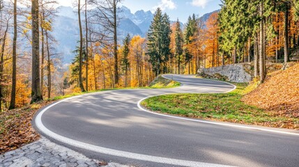 Fototapeta premium Scenic winding road through autumn forested mountains.
