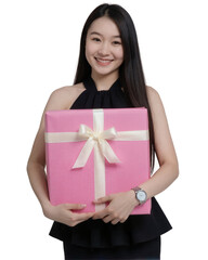 Asian woman with long dark hair, wearing a black dress, holding a pink gift box with a ribbon. on white background