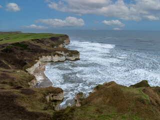Flamborough Head is a promontory, 8 miles (13 km) long on the Yorkshire coast of England, between the Filey and Bridlington bays of the North Sea. It is a chalk headland, with sheer white cliffs. 