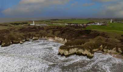 Flamborough Head is a promontory, 8 miles (13 km) long on the Yorkshire coast of England, between the Filey and Bridlington bays of the North Sea. It is a chalk headland, with sheer white cliffs. 