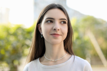 Portrait of beautiful teenage girl on city street