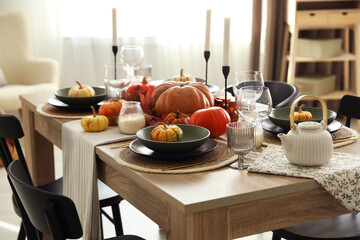 Stylish table setting with beautiful autumn decor in dining room