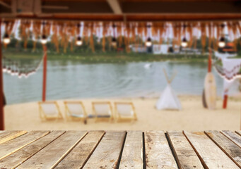Wooden table top on the beach or sea.Party on the beach  sunshine time concept.For montage product display or design key visual layout.View of copy space.