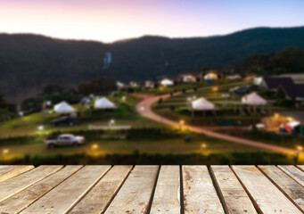 Wooden table top on camping ground mountain and grass field.Fresh and Relax concept.For montage product display or design key visual layout.View of copy space.