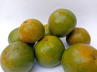 A bunch of fresh oranges arranged on a white background. 