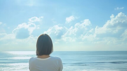 Fototapeta premium Person gazing at serene ocean view and sky.