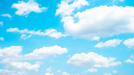 Clear blue sky with puffy white clouds, capturing the essence of a tranquil, sunny day in a simple...