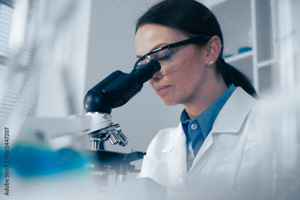 Poster in a modern lab, a dedicated scientist observes biological specimens through a highpowered microscop