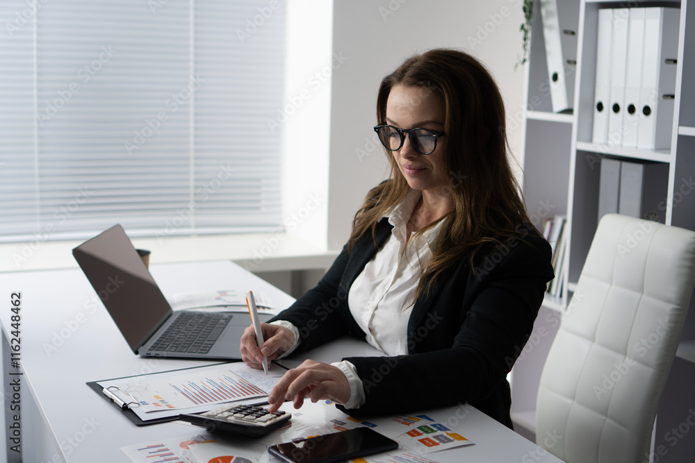Poster a hardworking business professional engages in analytical tasks at their organized desk, using tools