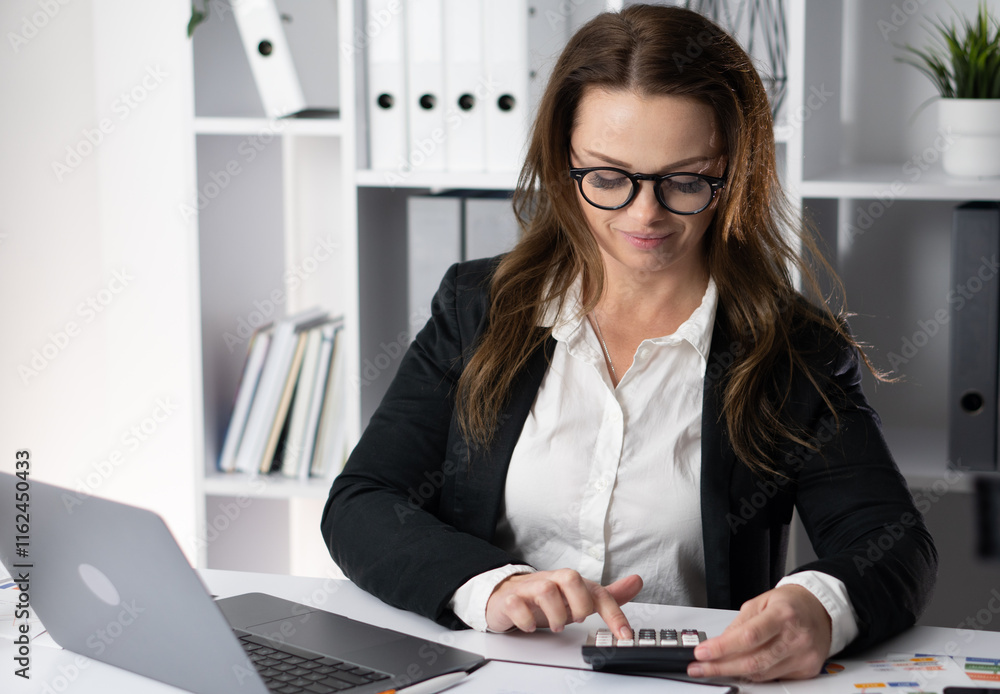 Poster a dedicated professional woman is actively engaged in her work in a modern office environment, utili
