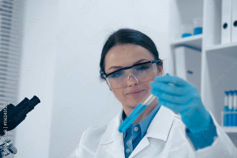 Poster In a wellorganized lab, an experienced scientist analyzes a complex chemical solution with precision while working in the fastevolving field of innovative research and development