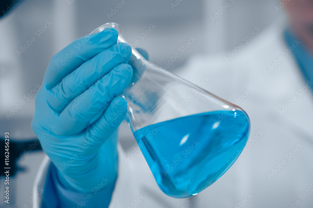 Poster in a wellequipped lab, a passionate scientist holds a vibrant blue liquid in a flask, highlighting t